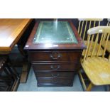 A mahogany and leather topped filing cabinet