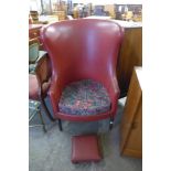 A George III style mahogany and red leather armchair and footstool