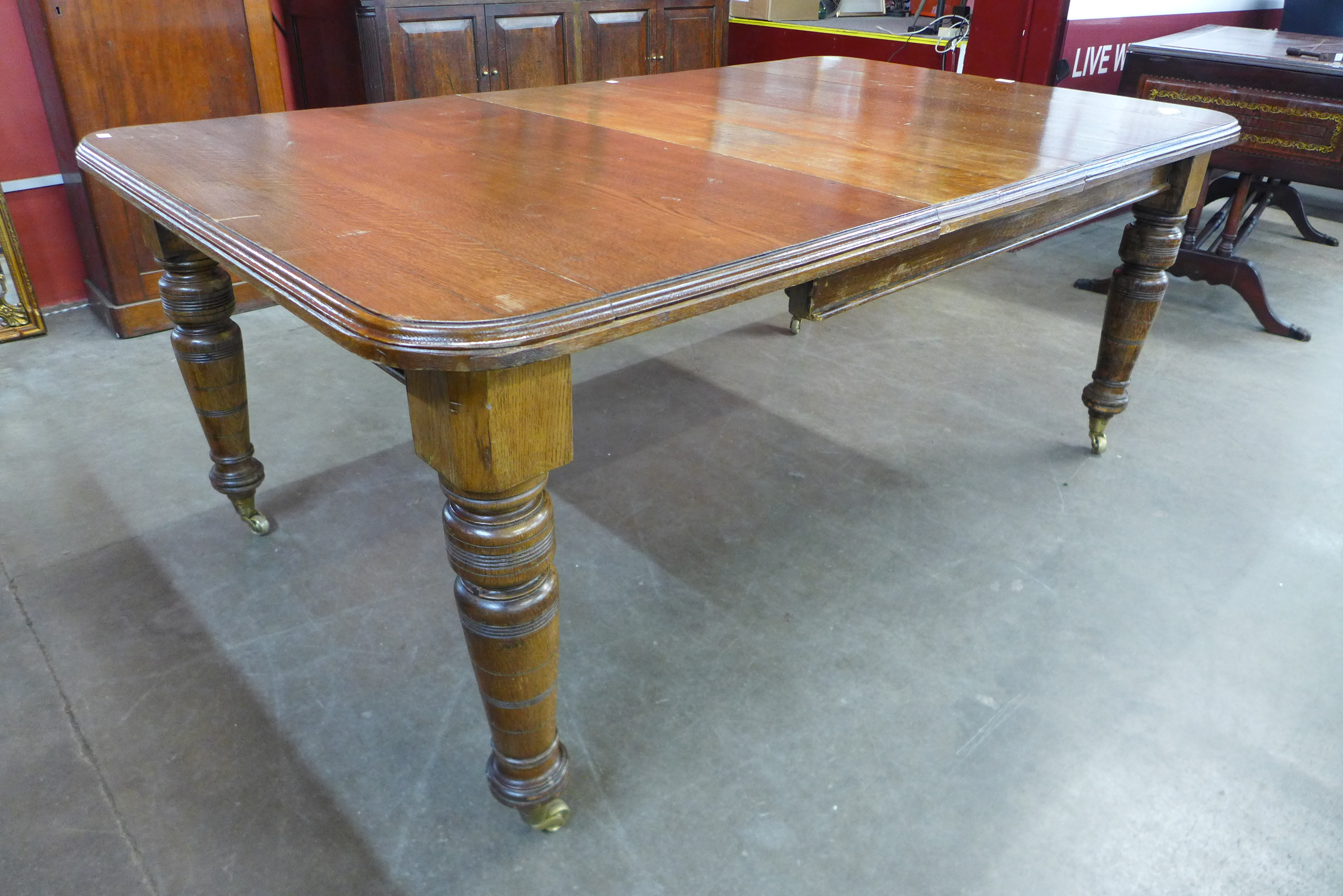 A Victorian oak extending dining table