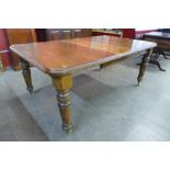 A Victorian oak extending dining table