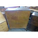 A burr walnut fitted cocktail cabinet, retailed by Hunters of Derby