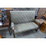 A 1930's oak and upholstered settle
