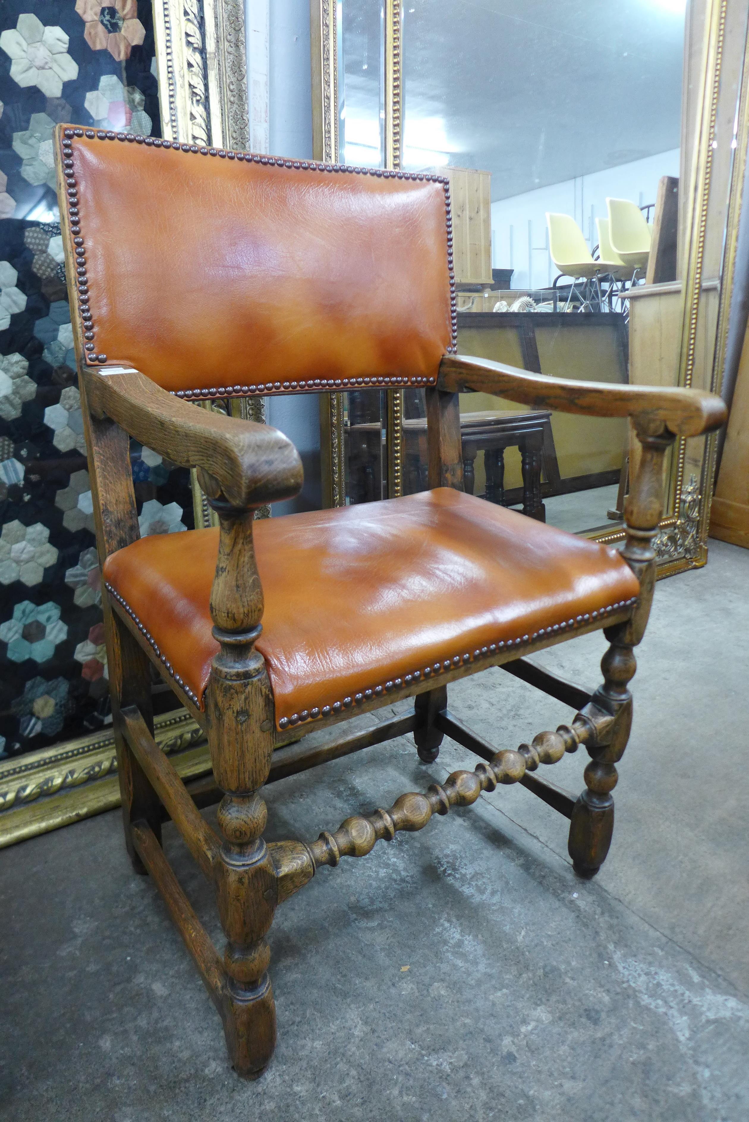 An Ipswich oak and upholstered open armchair