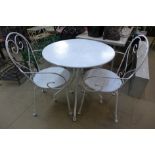 A metal circular garden table and two chairs