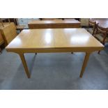 A teak extending dining table