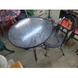 A metal and glass topped garden table and two chairs