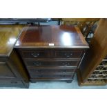 A small inlaid mahogany chest of drawers