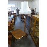 A beech standard lamp and an Art Deco oak folding firescreen