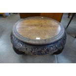 A 19th Century Chinese carved elm circular opium table