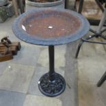 A cast iron bird bath