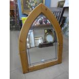 A large pine shield shaped mirror