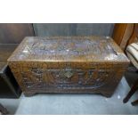 An oriental carved camphor-wood blanket chest