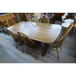 An Ercol Golden Dawn dining table and six Quaker chairs