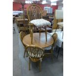 A beech circular kitchen table and four chairs