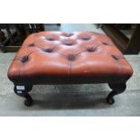 A mahogany and red leather footstool