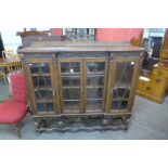 An early 20th Century carved oak four door breakfront bookcase