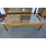 A teak and tiled top coffee table