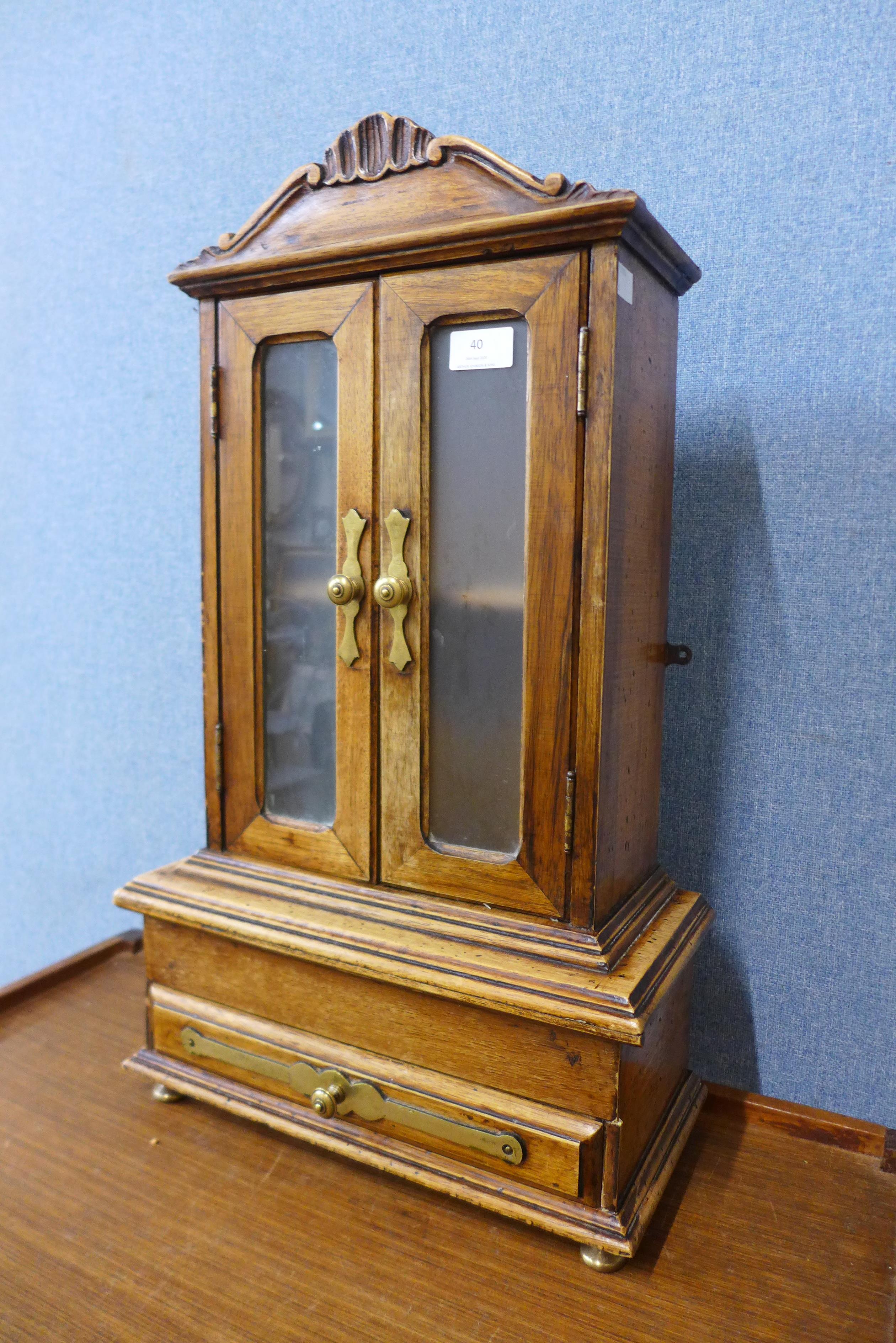 A miniature French fruitwood armoire, 63cms h