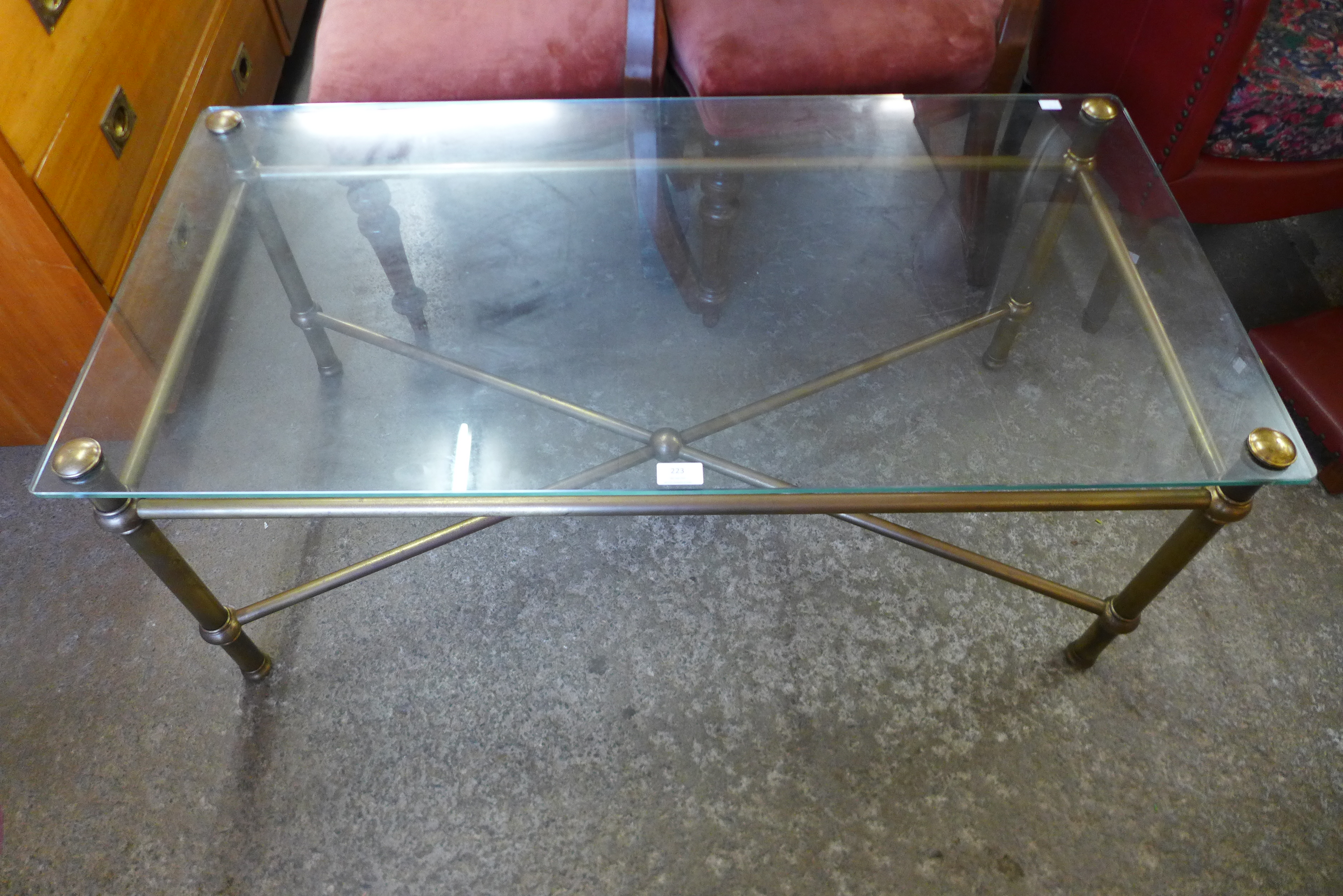 A brass and glass topped x-frame coffee table