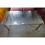 A brass and glass topped x-frame coffee table