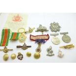 An Altrincham War Hospital Service Badge, two WWII Defence medals, military badges, etc.