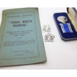 A For Exemplary Police Service medal, two uniform badges and a Nottinghamshire Constabulary booklet,