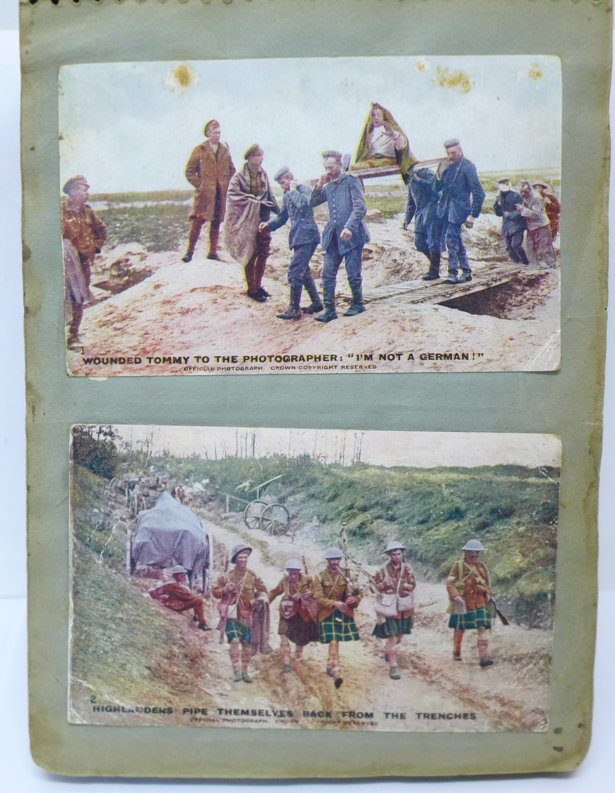 An album of approximately 100 early 20th Century WWI period postcards, mainly WWI related, (stuck