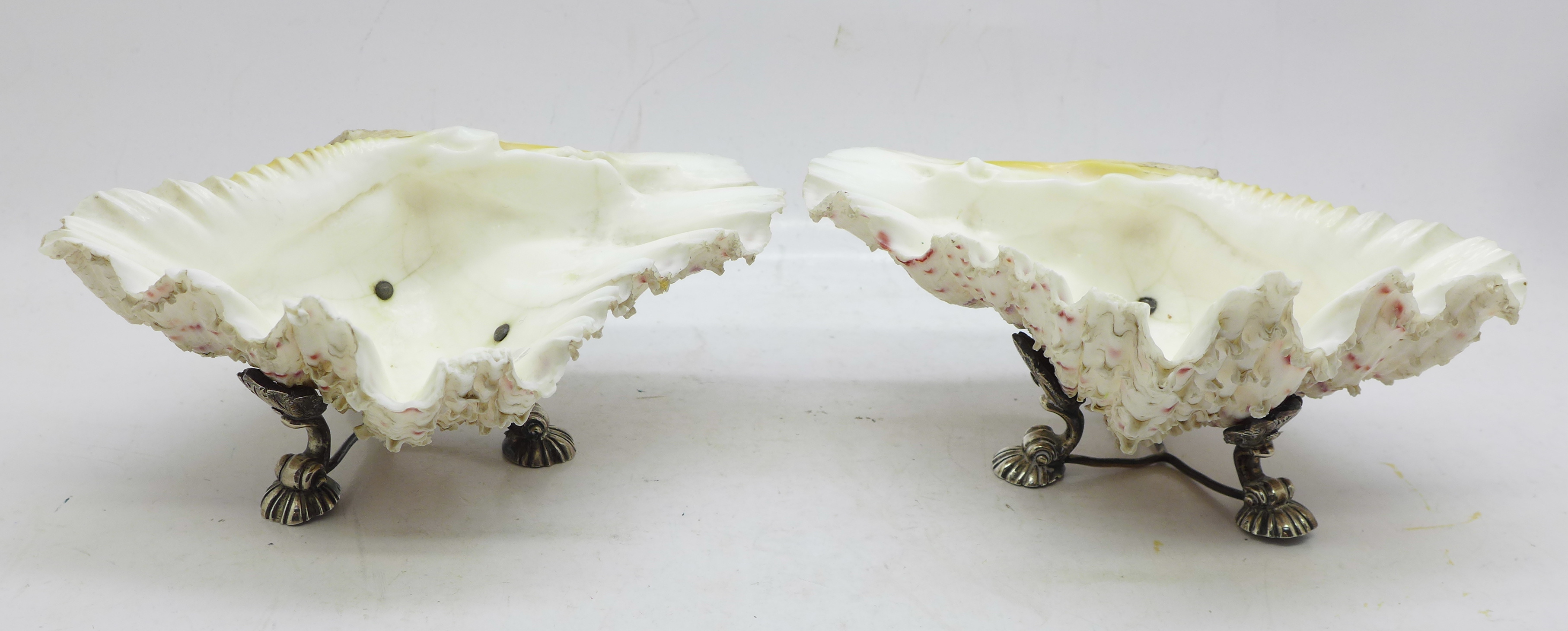 A pair of 19th Century silver plated shell salts, each 14cm wide, one metal base a/f
