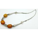A white metal and amber necklace