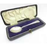 A silver christening gift spoon in a fitted case