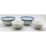 A pair of Chinese famille rose bowls and two Chinese blue and white bowls, all with character