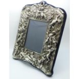 A hallmarked silver fronted/layered photograph frame decorated with cherubs, height 27cm