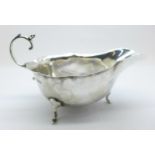 A George V silver sauce boat on three feet, by Adie Brothers Ltd., Chester 1926, 14cm in length,