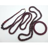 Two garnet necklaces, a garnet bangle and a red glass necklace
