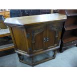 A carved oak two door credence cupboard