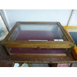 A beech and brass mounted table top display cabinet