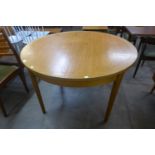 A teak extending dining table