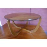 A teak circular coffee table