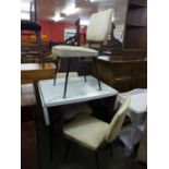 A Formica kitchen table and three chairs