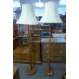 A pair of teak standard lamps