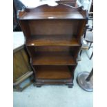 A mahogany open waterfall front bookcase