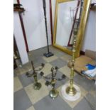 A small onyx and brass standard lamp and a pair of onyx and brass candlesticks