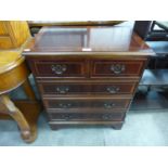 A small inlaid mahogany chest of drawers