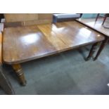 A Victorian oak extending dining table