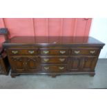 A George III style oak and mahogany crossbanded dresser, 88cms h, 200cms w, 55cms d