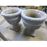 A pair of concrete campana garden urns