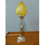 An Art Deco chromed spelter figural table lamp with amber glass shade