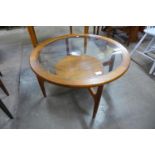 A teak and glass topped circular coffee table