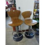 A pair of cast iron based bar stools