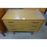 A teak chest of drawers